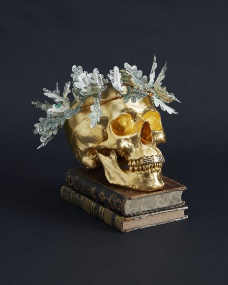 Gilded human skull sculpture with oak leaf wreath